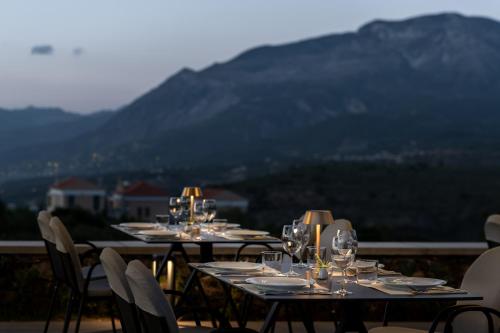 a group of tables with wine glasses on them at Searocks Exclusive Village in Kalamata