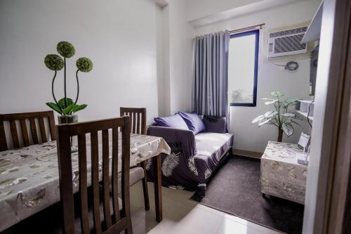 a small living room with a couch and a table at R and K staycation in Manila