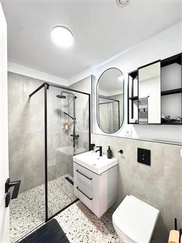 a bathroom with a toilet and a sink and a shower at AVA Studio Sinaia in Sinaia