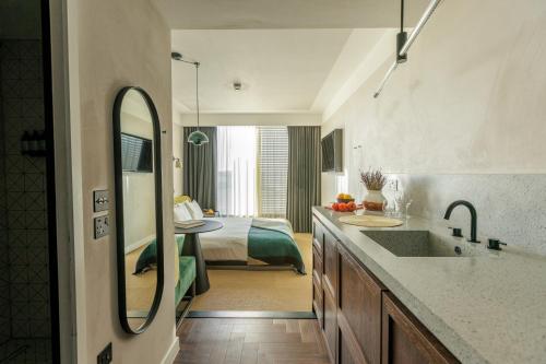 a bathroom with a sink and a room with a bed at Staycity Aparthotels London Dalston in London