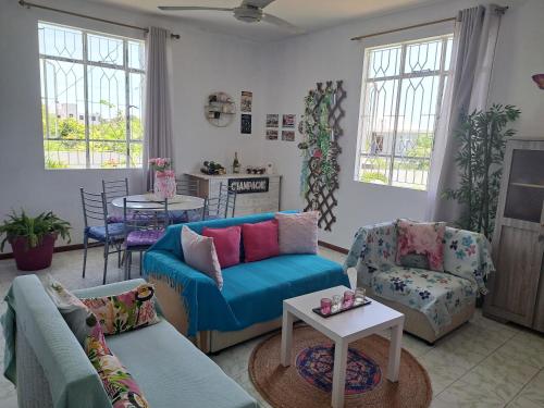 a living room with a blue couch and chairs at Belle maison in Goodlands