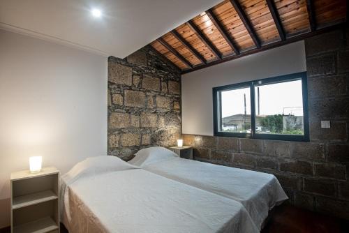 a bedroom with a large bed and a window at Porta 29 in Vila Franca do Campo