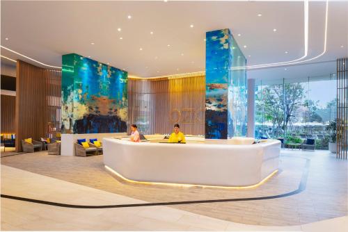 two people sitting in the lobby of a hotel at OZO North Pattaya in Pattaya