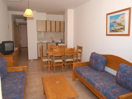 a living room with a couch and a table at Apartment Empuriabrava by Beach & Canals in Empuriabrava