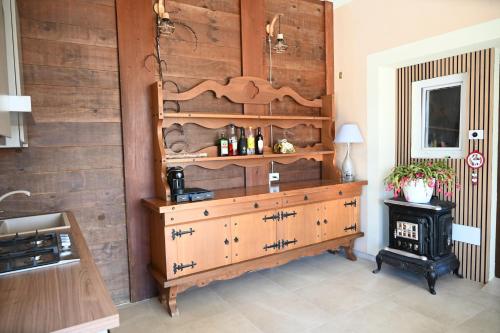 a room with a wooden wall and a wooden dresser at Ca' Tra Cielo e Monti in Frassinoro