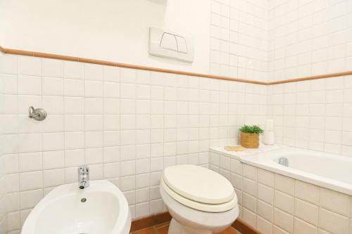 a white bathroom with a toilet and a sink at Top Living Apartments - De Lellis Torino Centro in Turin