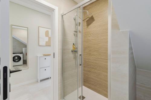 a shower with a glass door in a bathroom at Setúbal Serenity Villa I, By Home Match in Setúbal