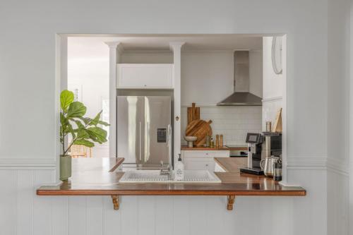 a kitchen with a counter with a laptop on it at Sunrise Guesthouse in Byron Bay