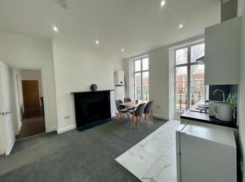 a kitchen and living room with a table and chairs at The 402 Residence in London
