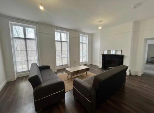 a living room with two couches and a coffee table at The 402 Residence in London