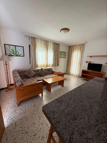 a living room with a couch and a table at Los Ficus in Playa del Ingles