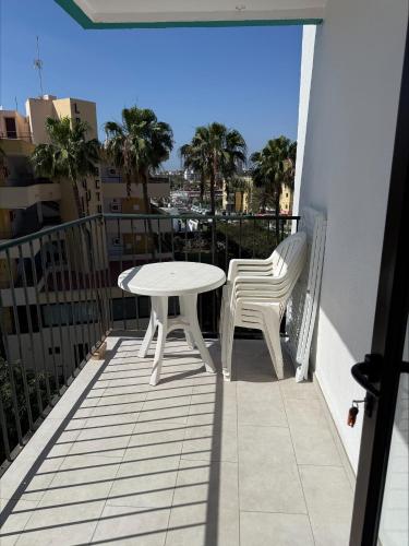 a white table and two chairs on a balcony at Los Ficus in Playa del Ingles