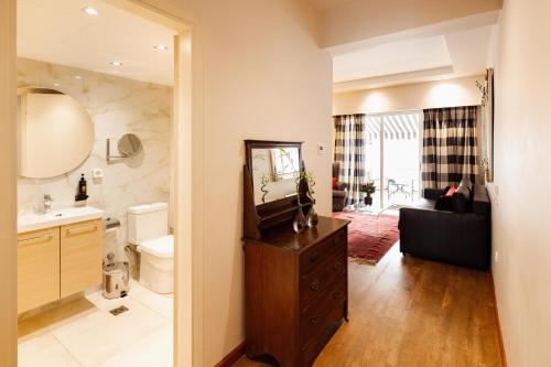 a bathroom with a sink toilet and a mirror at Best Western Plus Embassy Hotel in Athens