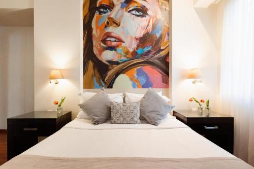 a bedroom with a bed with a painting on the wall at Best Western Plus Embassy Hotel in Athens