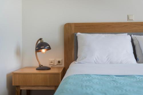 a bedroom with a bed and a lamp on a night stand at Villa Nina with Private Pool in Kolymvari