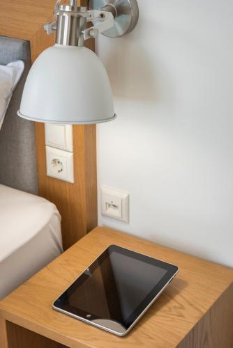 a table with a lamp and a tablet on it at Villa Nina with Private Pool in Kolymvari
