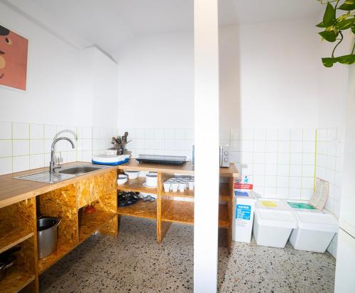 a kitchen with a sink and a counter with two toilets at Hostel Jamnik in Psary