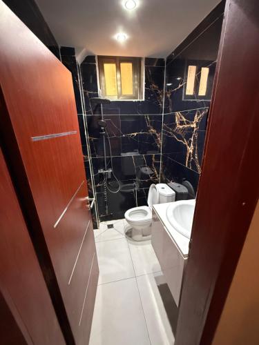 a bathroom with a toilet and a sink at Sylla in Dakar