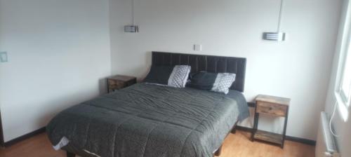 a bedroom with a bed with two pillows on it at Pequeño Depa 2 personas in Puerto Montt
