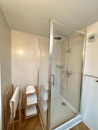 a shower with a glass door in a bathroom at Canopée - Appartement - Hyper centre ville in Quimper