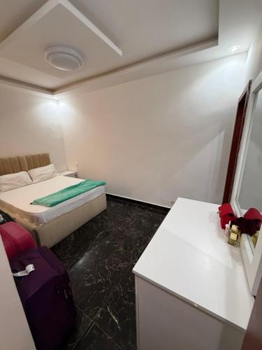 a small room with a bed and a desk at Sylla in Dakar