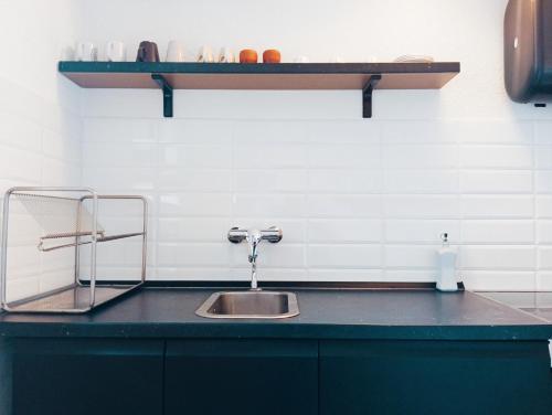 a kitchen with a sink and a black counter top at Mountain Suite in Raveo