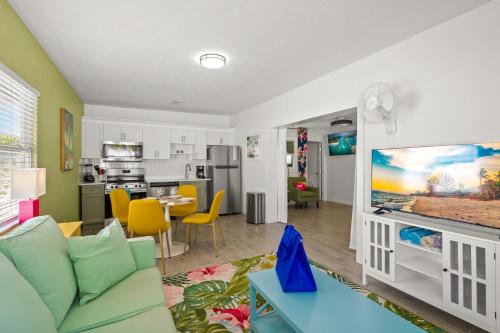 a living room with a couch and a flat screen tv at Walk to the Beach and Village - Hibiscus Villa in Siesta Key