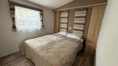 a bedroom with a large bed and a window at Andes in Dronrijp