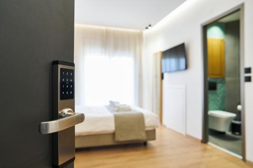 a hotel room with a bed and a bathroom at 42 Studio 8 in Komotini