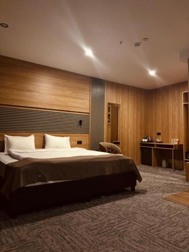 a bedroom with a large bed and a desk at Kent Room Hotel in Kapaklı