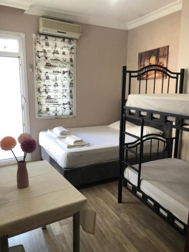 a room with two bunk beds and a table at Theodora Hostel in Istanbul