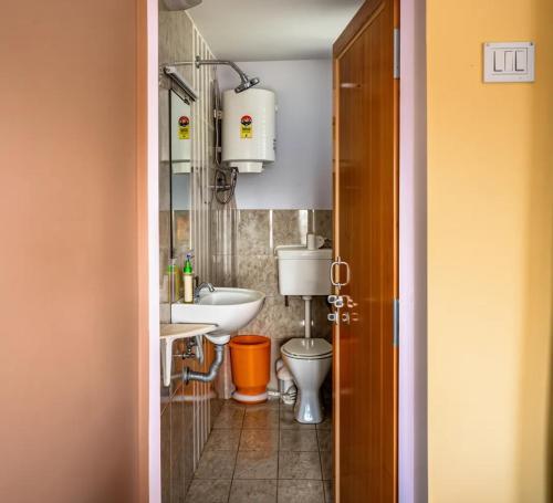 a bathroom with a toilet and a sink at Tara Inn in Varanasi