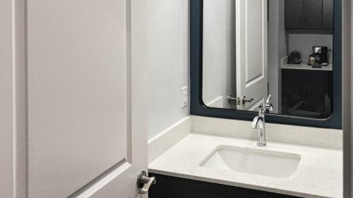 a bathroom with a sink and a mirror at Studio 6 Houston TX Pearland Medical Center in Houston