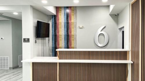a lobby with a large sign on a wall at Studio 6 Houston TX Pearland Medical Center in Houston