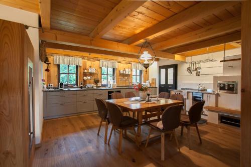 a kitchen and dining room with a wooden table and chairs at Ferienhaus Neubauer in Spielfeld