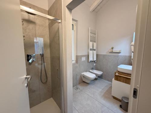 a bathroom with a shower and a toilet and a sink at Monza Downtown House Via Bartolomeo Zucchi 5 Monza in Monza