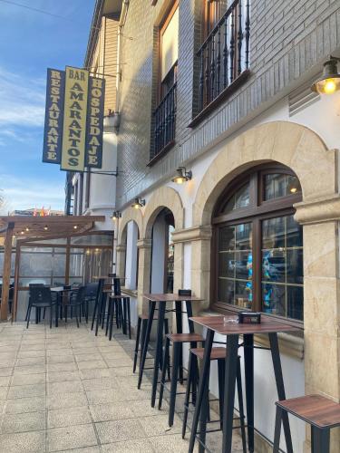 a row of tables and chairs outside of a restaurant at Amarantos in Suances