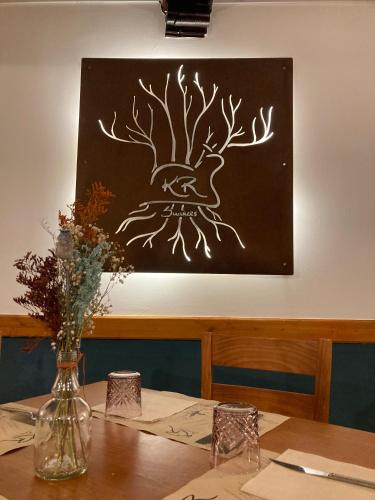 a picture of a tree on the wall above a table at Amarantos in Suances
