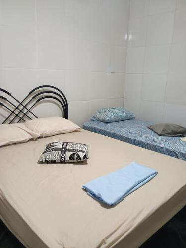 two beds sitting on top of a table with a napkin at Casa Hum com cozinha americana in Araruama