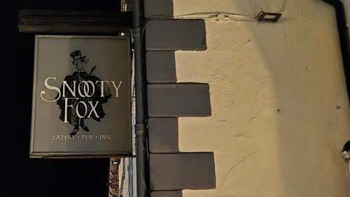 a sign on the side of a building at The Snooty Fox Pub in Kirkby Lonsdale
