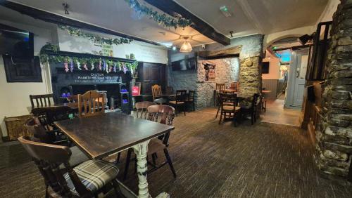 a restaurant with a table and chairs and a bar at The Snooty Fox Pub in Kirkby Lonsdale