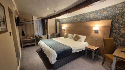 a hotel room with a bed and a desk at The Snooty Fox Pub in Kirkby Lonsdale