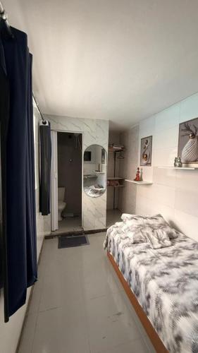 a bedroom with a bed and a bathroom at Alure 1 in Belo Horizonte