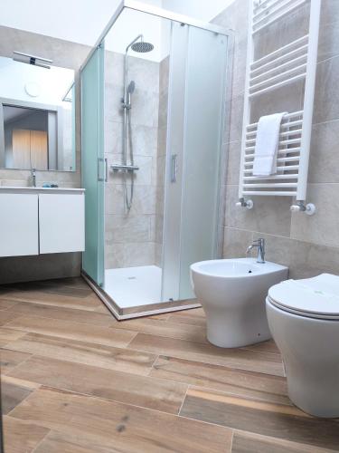 a bathroom with a shower and a toilet and a sink at Central in Casarile