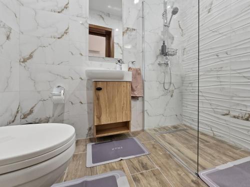 a bathroom with a toilet and a sink and a shower at Open Park Views 2 BR modern apartment 4 in St. Paul's Bay
