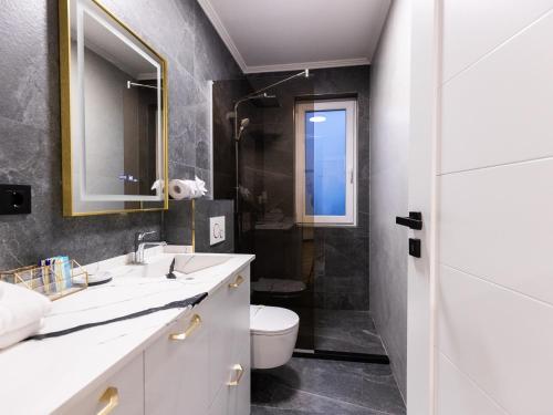 a bathroom with two sinks and a toilet at Nubia Central Apartments in Bistriţa