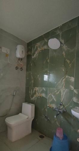 a bathroom with a toilet and a sink at Nandi Holiday Homestay in Nandi