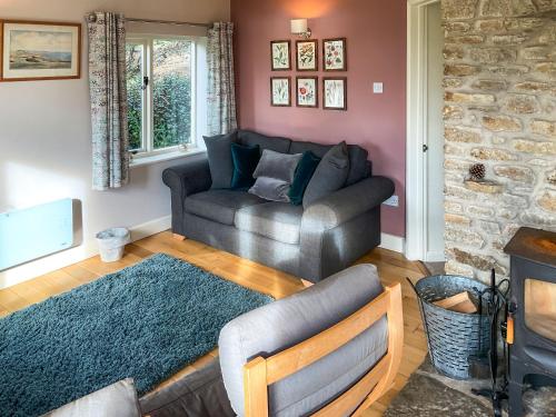 a living room with a couch and a chair at Whispering Pines - Uk51248 in Swyre