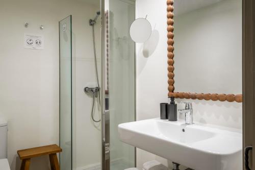a bathroom with a sink and a shower at BYPILLOW Cluc Begur in Begur