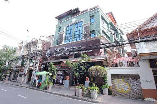 a building on a street with plants on the sidewalk at Super OYO 484 Pannee Residence Khaosan Sha Plus in Bangkok